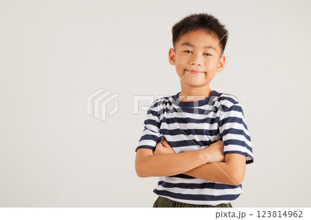 Asian happy portrait cute young kid boy smiling confidence with arms crossed studio shot isolated on white background and copy space, primary children person lifestyle arm folded 123814962