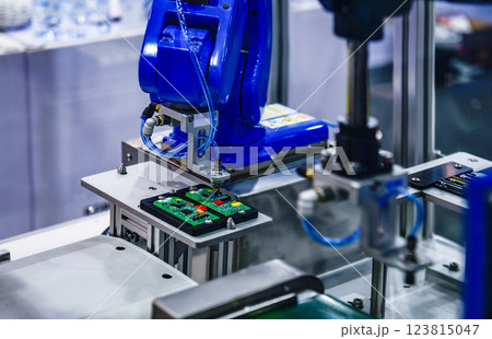 Automatic robots for assembling electronic circuit boards in factories 123815047
