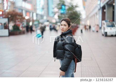 woman traveler visiting in Shanghai, China. Happy Female Tourist sightseeing in Nanjing road, shopping district of Shanghai. landmark and popular for tourism attractions. Travel and Vacation concept woman traveler visiting in Shanghai, China. Happy Female Tourist sightseeing in Nanjing road, shopping district of Shanghai. landmark and popular for tourism attractions. Travel and Vacation concept 123818287