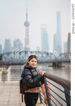 woman traveler visiting in Shanghai, China. Happy Female Tourist sightseeing Oriental Pearl Tower and Waibaidu Bridge view. landmark and popular for tourism attractions. Travel and vacation concept 123818297