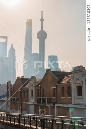 woman traveler visiting in Shanghai, China. Female Tourist with backpack sightseeing Shanghai view of Lujiazui in Hongkou Gang canal of Shanghai. landmark and popular for tourism attraction woman traveler visiting in Shanghai, China. Female Tourist with backpack sightseeing Shanghai view of Lujiazui in Hongkou Gang canal of Shanghai. landmark and popular for tourism attraction 123818308