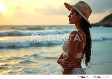 Woman in a hat by the beach. 123820057