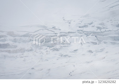 Groups of mountaineers crossing difficult glacier terrain, distant shot, Pamir Mountains, Kyrgyzstan Groups of mountaineers crossing difficult glacier terrain, distant shot, Pamir Mountains, Kyrgyzstan 123820282