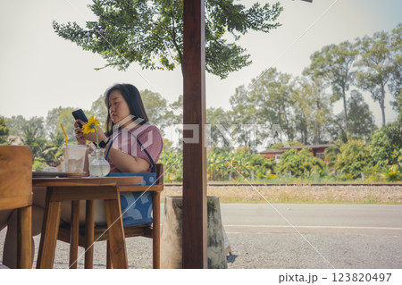 happy and cheerful with asian woman enjoy with coffee and cake in coffee shop 123820497