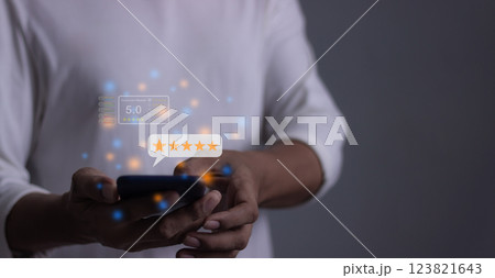 Young Man hand holding Smart Phone with five star to review and give 5 stars  123821643