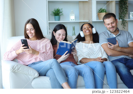 Four roommates or friends enjoying of different hobbies 123822464