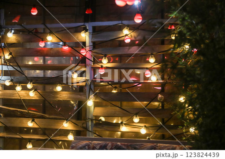 Colorful string lights illuminate a cozy outdoor space in Bucharest, Romania during a festive evening gathering 123824439