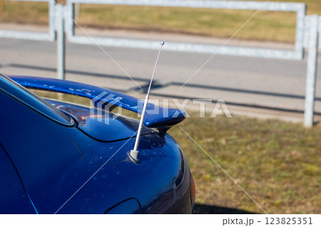 A blue car with a white antenna on top of it A blue car with a white antenna on top of it 123825351