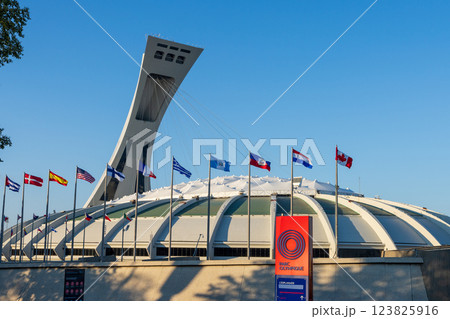 Montreal, Quebec, Canada - August 10 2021 : Montreal Olympic Stadium (The Big O) with flags of the world. 123825916