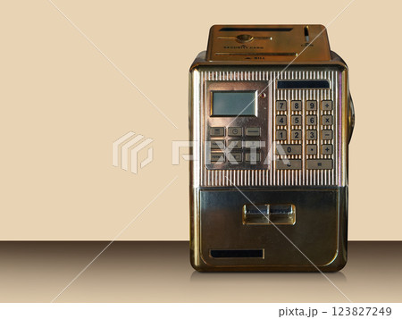 front view gold metal Mini ATM on gradient brown floor, cream wall background, technology, object, fashion, decor,  decoration, copy space 123827249