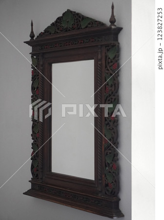 Mirror with wooden frame, mounted on a white cement wall on the side background, object, decor, decoration, copy space Mirror with wooden frame, mounted on a white cement wall on the side background, object, decor, decoration, copy space 123827253