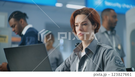 Airport Security Checkpoint: Close Up of Female TSA Officer Working on Laptop 123827661