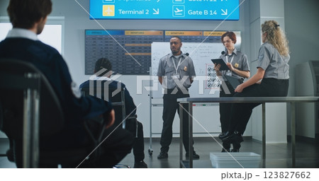 Planning Session with Airport Security Staff: Officer Holds Briefing, Instructs Team of Workers 123827662