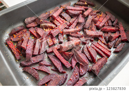 Juicy beetroot slices baked in the oven on a Teflon-coated baking sheet Juicy beetroot slices baked in the oven on a Teflon-coated baking sheet 123827830