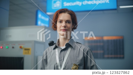 Airport Security Checkpoint: Portrait of Female Security Officer Smiling, Looking at Camera Airport Security Checkpoint: Portrait of Female Security Officer Smiling, Looking at Camera 123827862