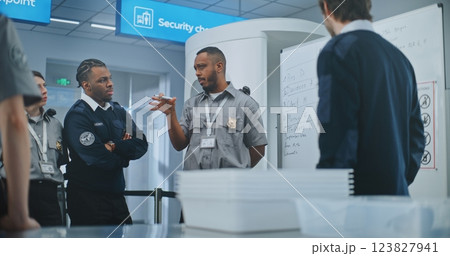 TSA Officer Conducts Planning Session, Uses Whiteboard, Provides Instructions to Team of Workers TSA Officer Conducts Planning Session, Uses Whiteboard, Provides Instructions to Team of Workers 123827941