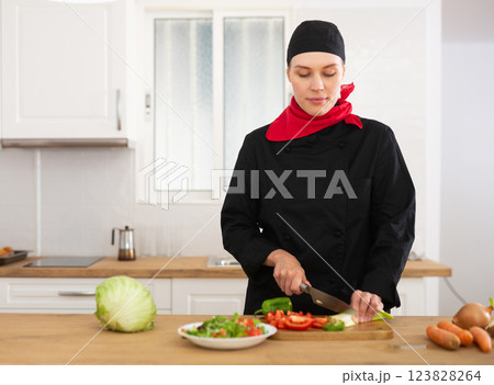 Female cook preparing food in kitchen 123828264