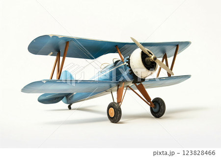 Detailed photo of a classic blue biplane model, showcasing its double wings and propeller, isolated on a clean white backdrop 123828466