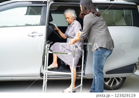 Asian senior woman patient sitting on walker prepare get to her car, healthy strong medical concept. Asian senior woman patient sitting on walker prepare get to her car, healthy strong medical concept. 123829119