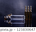 Ampoules with medicine on glossy black background 123830647