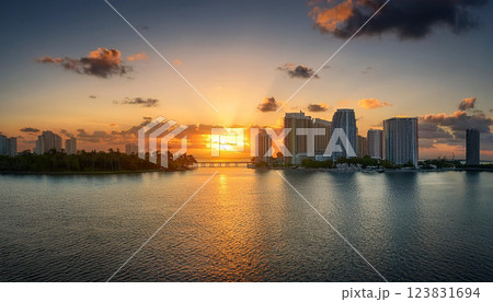 A beautiful sunset over a city with a large body of water in the background 123831694