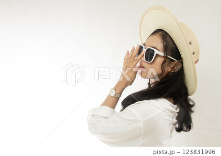 Beautiful young fashion woman wearing straw hat, sunglasses side view posing with hand on nose isolated on white, negative space Beautiful young fashion woman wearing straw hat, sunglasses side view posing with hand on nose isolated on white, negative space 123831996