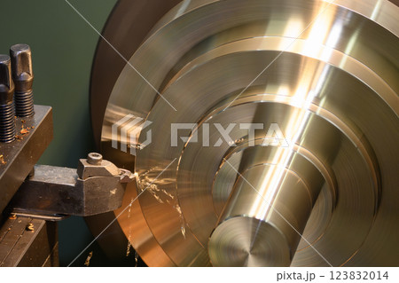 The lathe machine finish cut the brass material parts by lathe tools. 123832014