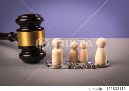Wooden human figures on a gray table. Divorce and child custody dispute concept Wooden human figures on a gray table. Divorce and child custody dispute concept 123832113