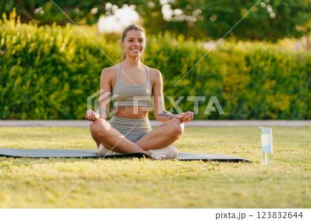Living a Healthy Lifestyle A Woman Meditating Peacefully in the Great Outdoors Surrounded by Nature Living a Healthy Lifestyle A Woman Meditating Peacefully in the Great Outdoors Surrounded by Nature 123832644