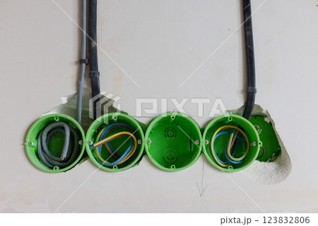 Green electric sockets box in the wall. Electric outlet installation. Closeup. Green electric sockets box in the wall. Electric outlet installation. Closeup. 123832806