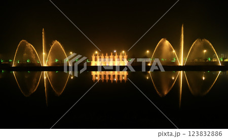 Reflection of the night light show on the water. 123832886