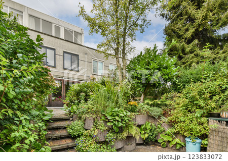 A vibrant garden featuring diverse greenery and stylish contemporary architecture, enhancing the natural beauty of the outdoor space. 123833072