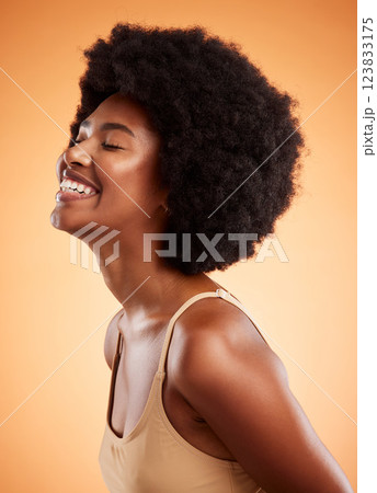 Happy black woman, cosmetic beauty and natural skincare or haircare wellness. African girl skin health, afro fun hair and healthy happiness glow lifestyle in studio against orange background 123833175