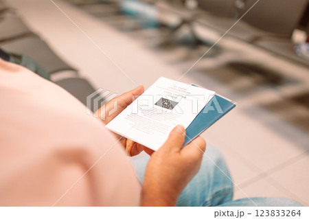 Qr code, check in and man with a phone for a ticket, airplane booking and information at airport. Travel, website and hand of a businessman reading a barcode on a mobile for a work trip or vacation 123833264