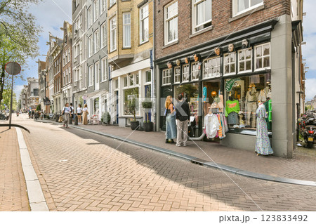 A picturesque street scene featuring an array of shops and people. The vibrant architecture adds a unique charm to this lively urban setting. A picturesque street scene featuring an array of shops and people. The vibrant architecture adds a unique charm to this lively urban setting. 123833492