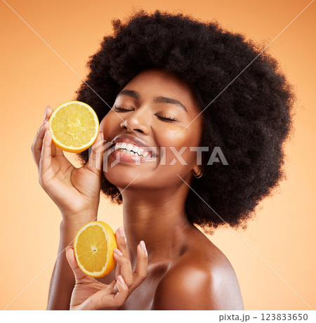 Beauty, skincare and orange with a model black woman in studio on a color wall background. Skin, health and vitamin c with a young female holding fruit for wellness, nutrition or natural treatment Beauty, skincare and orange with a model black woman in studio on a color wall background. Skin, health and vitamin c with a young female holding fruit for wellness, nutrition or natural treatment 123833650