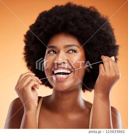 Flossing, dental and black woman cleaning teeth against an orange studio background. Young, African and thinking model with idea while getting results from care and wellness of mouth and tooth health Flossing, dental and black woman cleaning teeth against an orange studio background. Young, African and thinking model with idea while getting results from care and wellness of mouth and tooth health 123833662