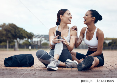 Phone, fitness and women on social media in the city of London after workout together in the street. Happy, smile and healthy athlete friends with funny mobile app on tech after training outside 123834009