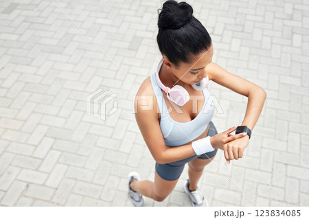Exercise, runner and black woman with digital smartwatch to track steps, calories counter or heart rate. Sports health, running monitor and fitness app to check wellness, training and workout support 123834085