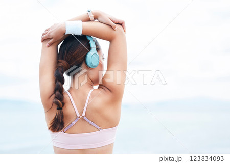 Fitness, sports and woman stretching with music on in warm up for training, cardio exercise and running workout. Tattoo, headphones and back view of girl athlete or runner ready to start challenge Fitness, sports and woman stretching with music on in warm up for training, cardio exercise and running workout. Tattoo, headphones and back view of girl athlete or runner ready to start challenge 123834093