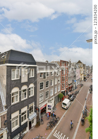 A picturesque view of traditional Dutch architecture lining a serene canal in Amsterdam, showcasing vibrant facades and a bustling street life. A picturesque view of traditional Dutch architecture lining a serene canal in Amsterdam, showcasing vibrant facades and a bustling street life. 123834200