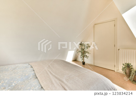 A serene bedroom scene featuring a soft bed with light textiles and a simple decor, creating a relaxing atmosphere perfect for rest and tranquility. A serene bedroom scene featuring a soft bed with light textiles and a simple decor, creating a relaxing atmosphere perfect for rest and tranquility. 123834214