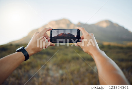 Hands, phone and mountain picture in nature for adventure, travel and countryside in the outdoors. Hand of traveler taking a photo of the natural environment with mobile smartphone in South Africa 123834561