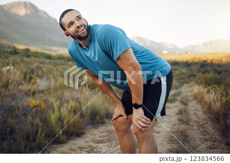 Running, fitness and man thinking in nature while training in countryside for health. Athlete runner with smile, motivation and idea on a run on a dirt path or field for exercise, workout and cardio 123834566