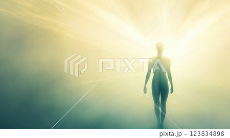 Mystical silhouette of human figure walking towards bright light source 123834898