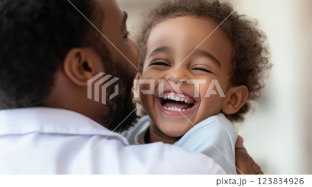 Joyful moment, african male adult and child sharing laughter 123834926