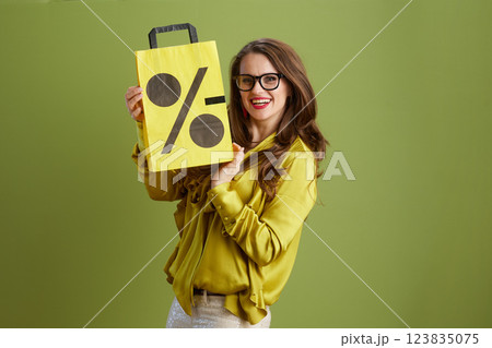 happy female in green blouse and glasses on green 123835075