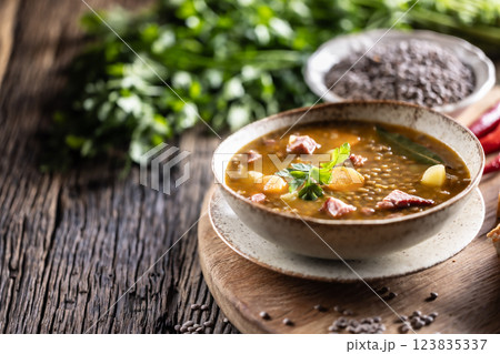 Lentil stew or soup with smoked pork meat, traditional Slovak or Czechv food Lentil stew or soup with smoked pork meat, traditional Slovak or Czechv food 123835337
