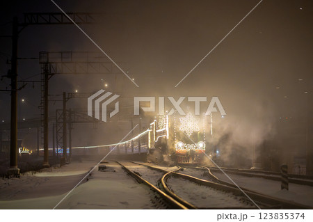 Retro Christmas steam train at night in the city on Christmas Eve and New Year in Russia. 123835374