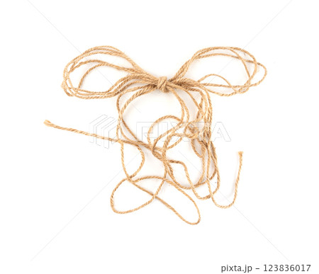 Twine rope piece isolated, jute loop fragment, beige packaging cord knots, old natural line cable Twine rope piece isolated, jute loop fragment, beige packaging cord knots, old natural line cable 123836017